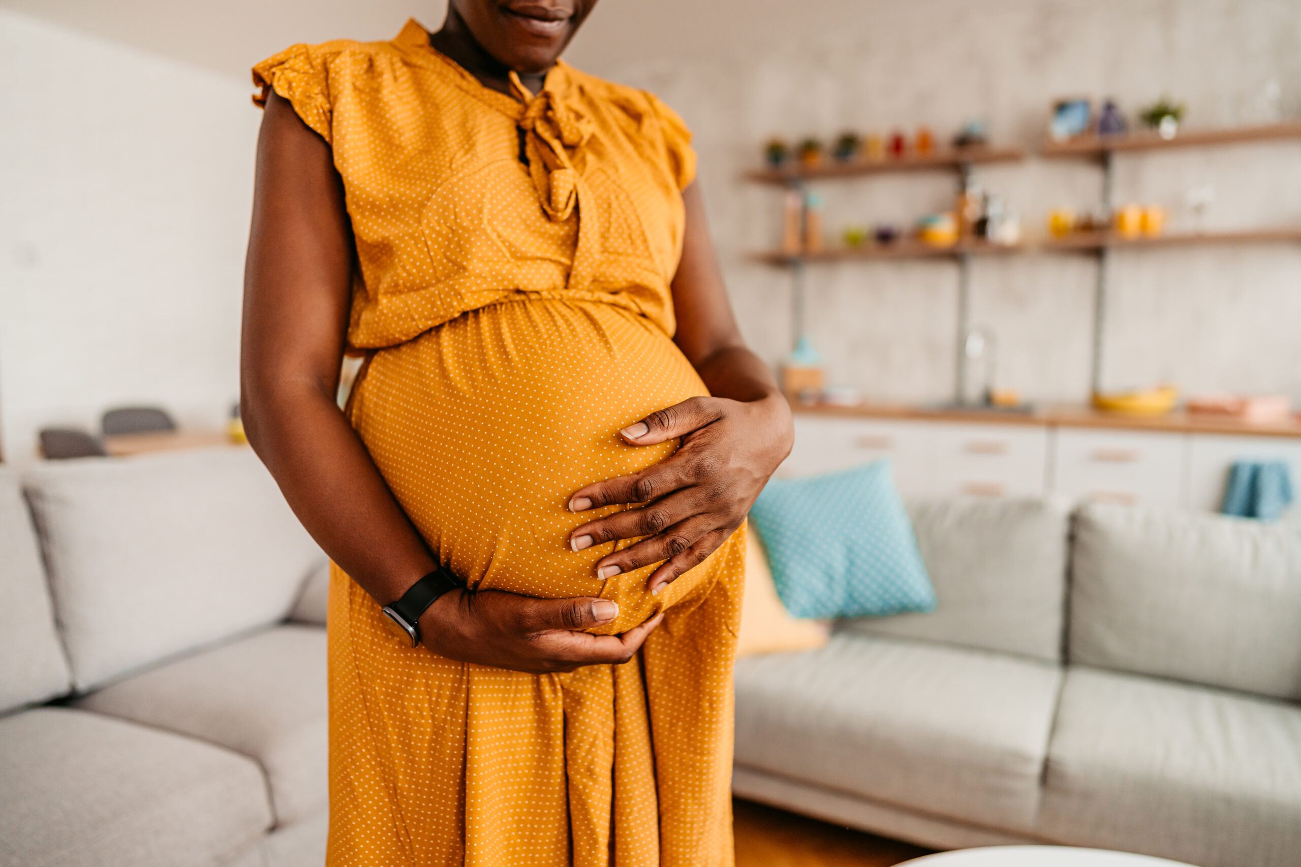 Photo of a pregnant woman holding her belly