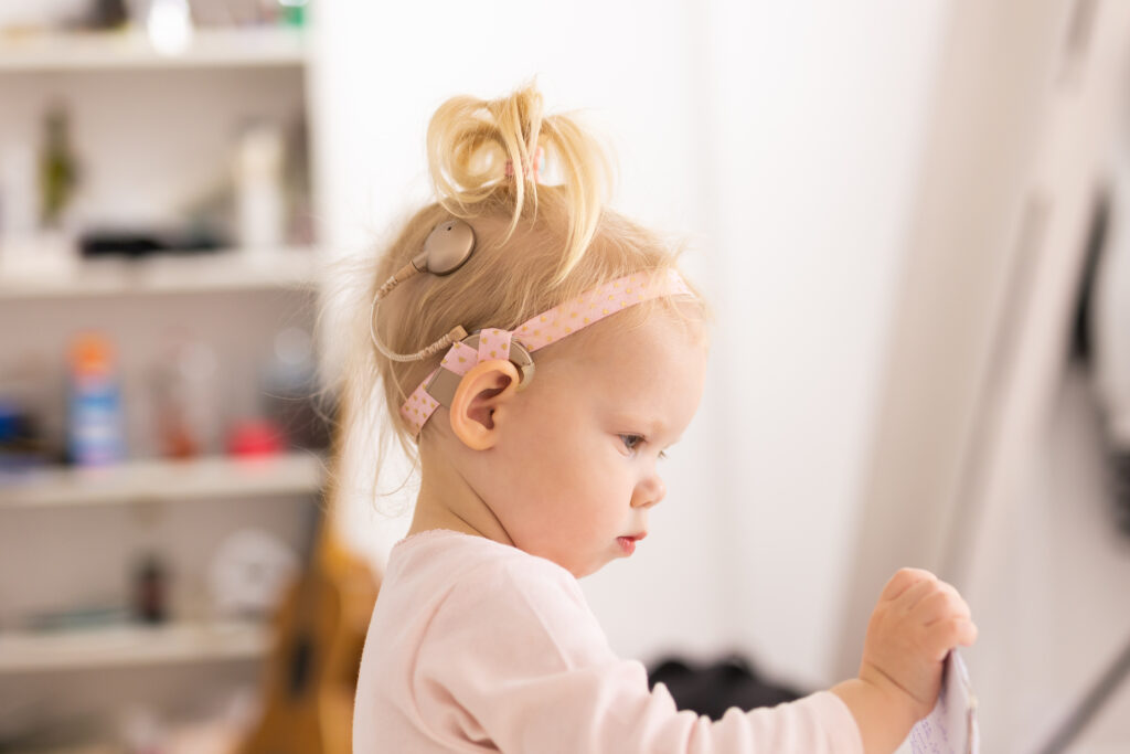 Photo of a toddler with a cochlear implant